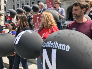 Protesters hold large black balloons symbolizing the methane pollution from Pennsylvania's oil and gas industry.