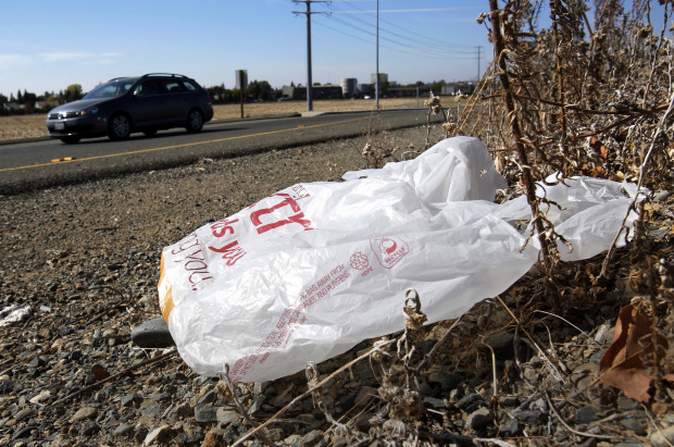 This Oct. 25, 2013 file photo shows single-use plastic bag along a roadside in Sacramento, Calif. California. A bill on Pa. Gov. Wolf's desk would forbid municipalities from banning plastic bags in the state.