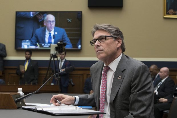 Energy Secretary Rick Perry listens to a statement by Energy and Commerce Committee Chairman Greg Walden, R-Ore., on TV monitor, during a hearing about the electrical grid, on Capitol Hill in Washington, Thursday, Oct. 12, 2017.