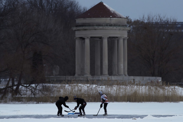 Youths play ice hockey on a frozen pond at Franklin Delano Roosevelt Park during a winter storm, Thursday, Jan. 4, 2018, in Philadelphia.