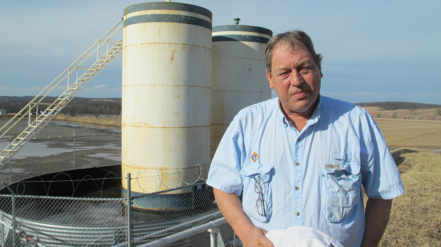 Jim Barrett stands next to a wellpad on his farm in Bradford County. He says Chesapeake Energy, which drilled four natural gas wells on his land, is cheating him out of royalty money.