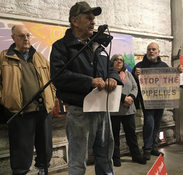 A landowner rips up an offer of compensation from PennEast at a rally February 2, 2018.