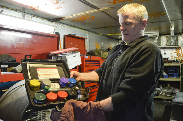 Scott Reynolds, owner of Express Transmission in Beaver County, shows an array of gas cap adapters. The adapters are used as a part of Pennsylvania's vehicle emission testing program.